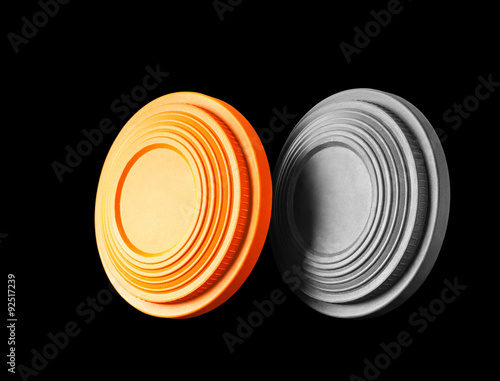 Closeup of two clay pigeon targets isolated on a black background. Clipping path inctuded.