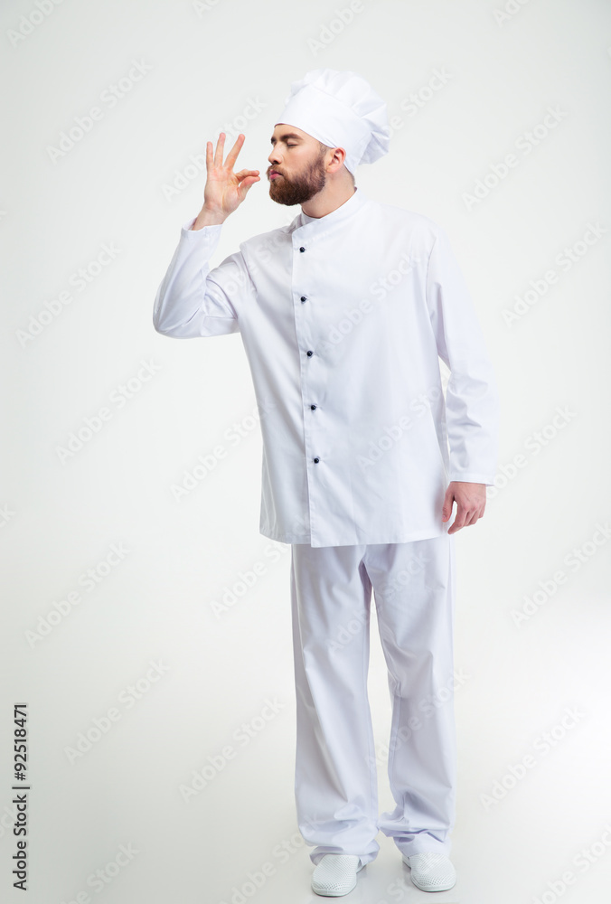 Male chef cook making tasty gesture by kissing fingers