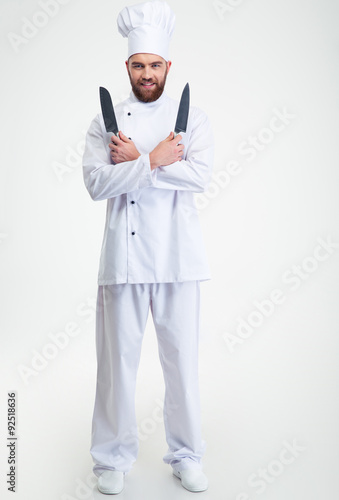 Happy chef cook standing with two knifes