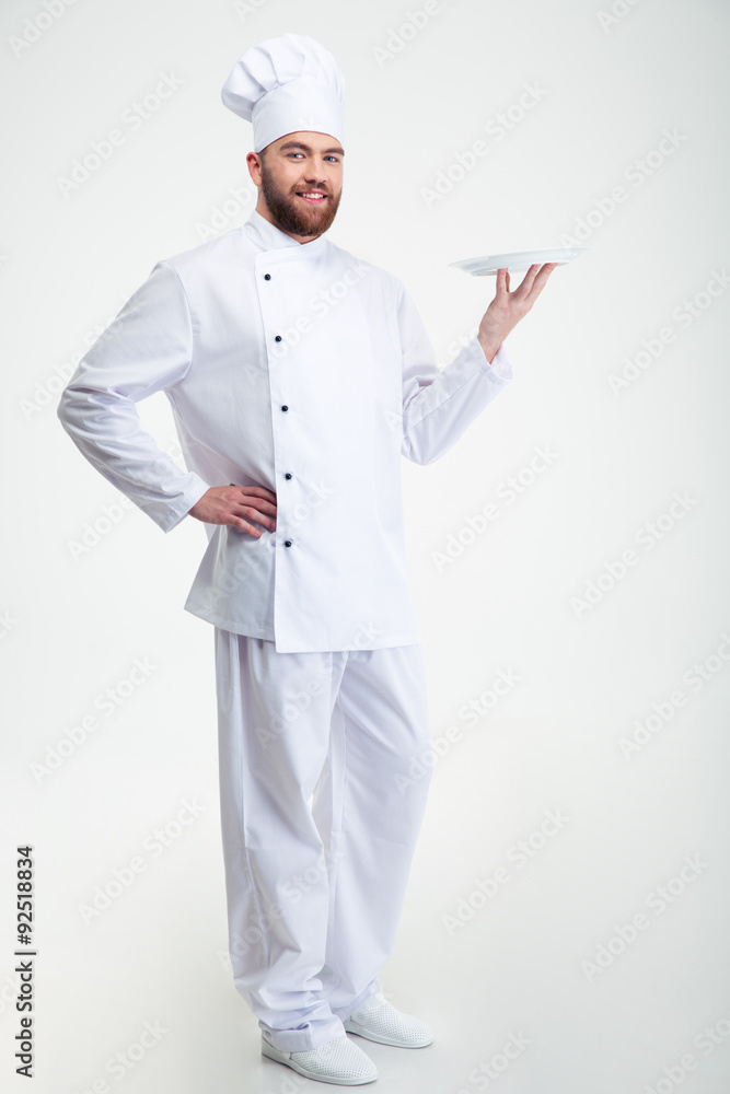 Portrait of a happy male chef cook standing with plate Portrait of a happy male chef cook standing with plate