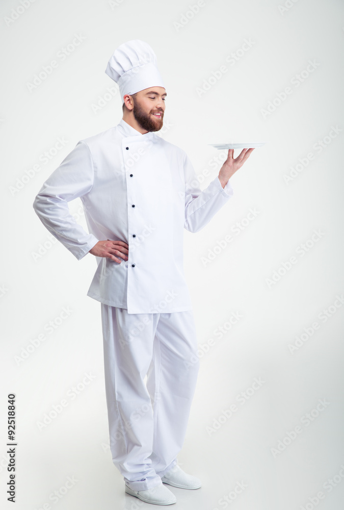 Happy male chef cook standing with plate