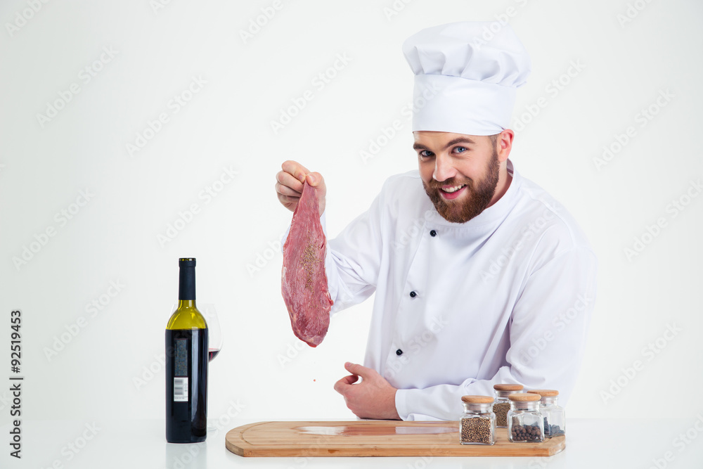 Happy male chef cook holding fresh meat Happy male chef cook holding fresh meat