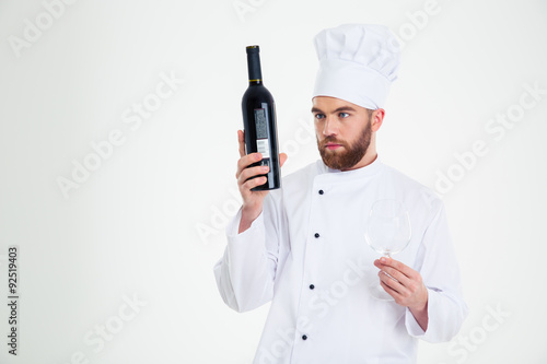 Male chef cook holding bottle with wine
