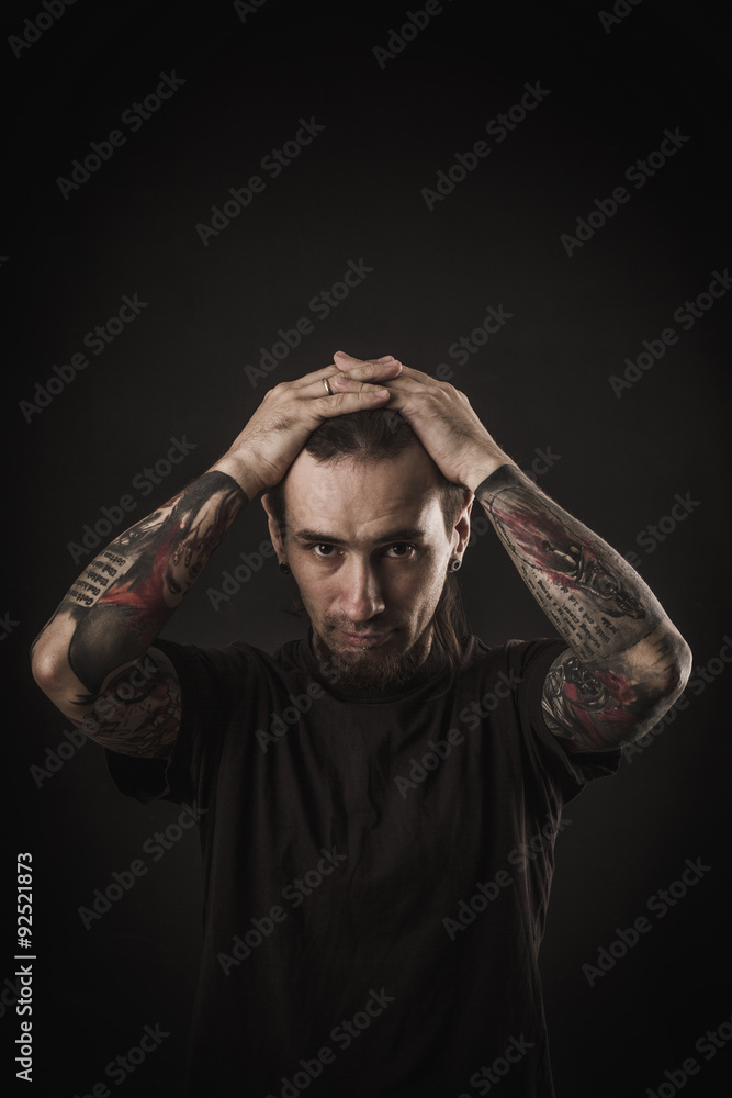 Portrait of a man with naked torso and tattooes Portrait of a man with naked torso and tattooes