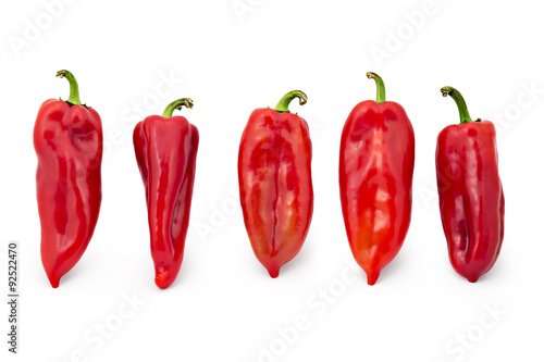 Five fresh sweet red peppers isolated on white background