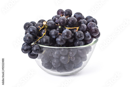 Fresh ripe red grapes clusters in a bowl on white background