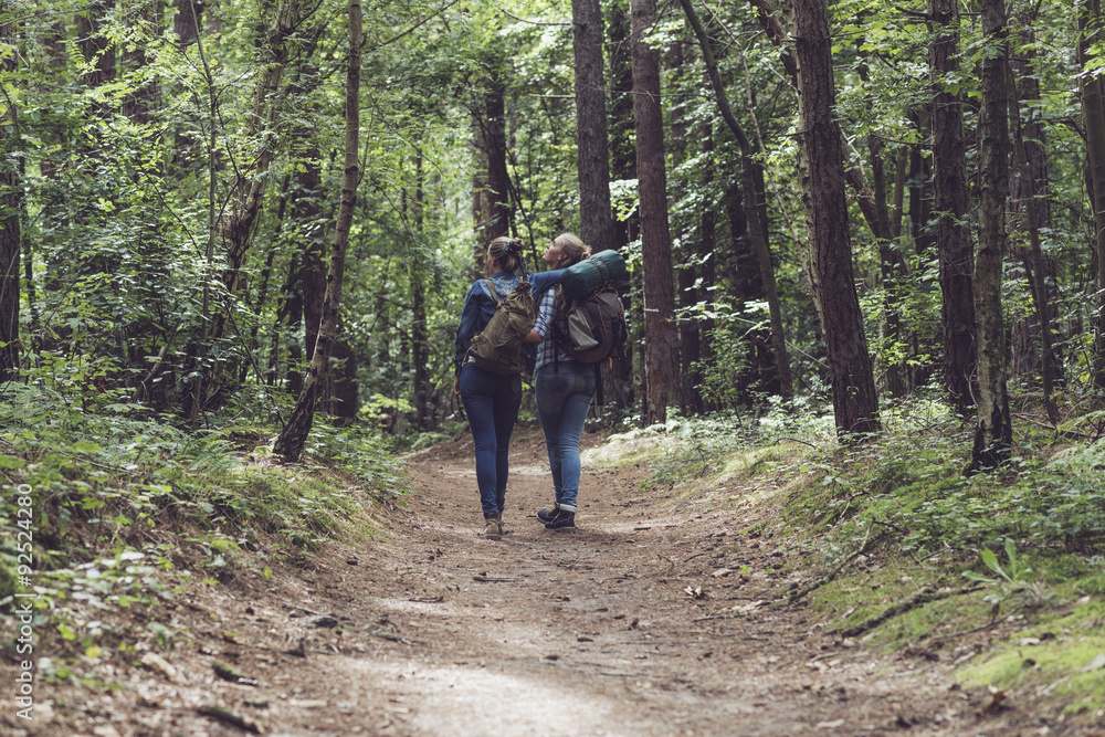 Two friends hiking in forest.