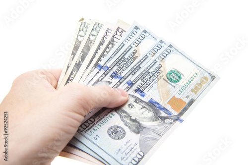 Hand holding various dollar notes. All on white background.