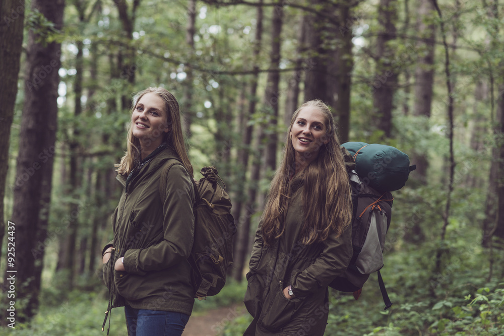 Happy twin sister hiking in forest. Happy twin sister hiking in forest.