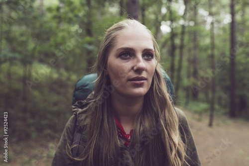 Hiking blonde woman in forest.