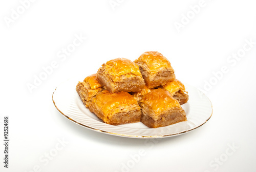 Sweet Baklava on plate isolated on white background.