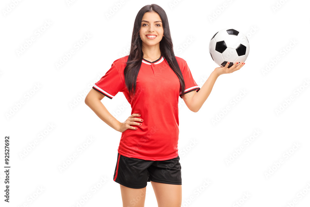Female soccer player in red jersey holding a ball