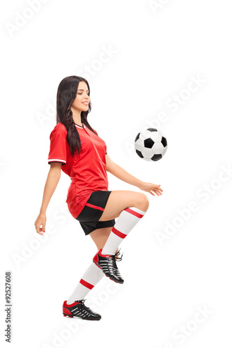 Female soccer player juggling a ball