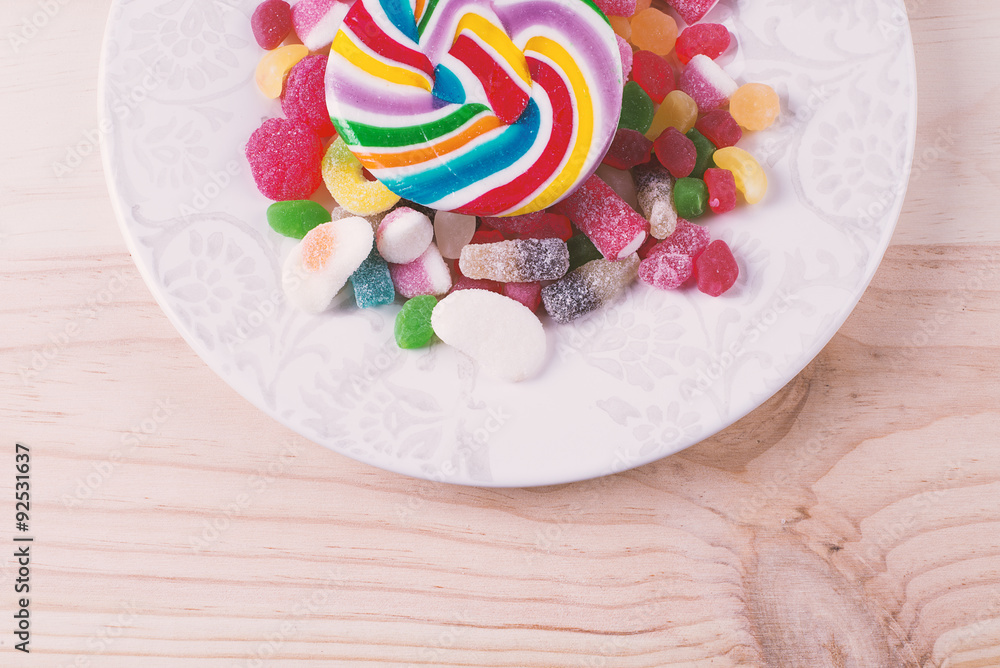 Lollipop candy of various colors on a plate Lollipop candy of various colors on a plate