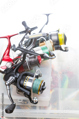 fishing reels on storage boxes with baits