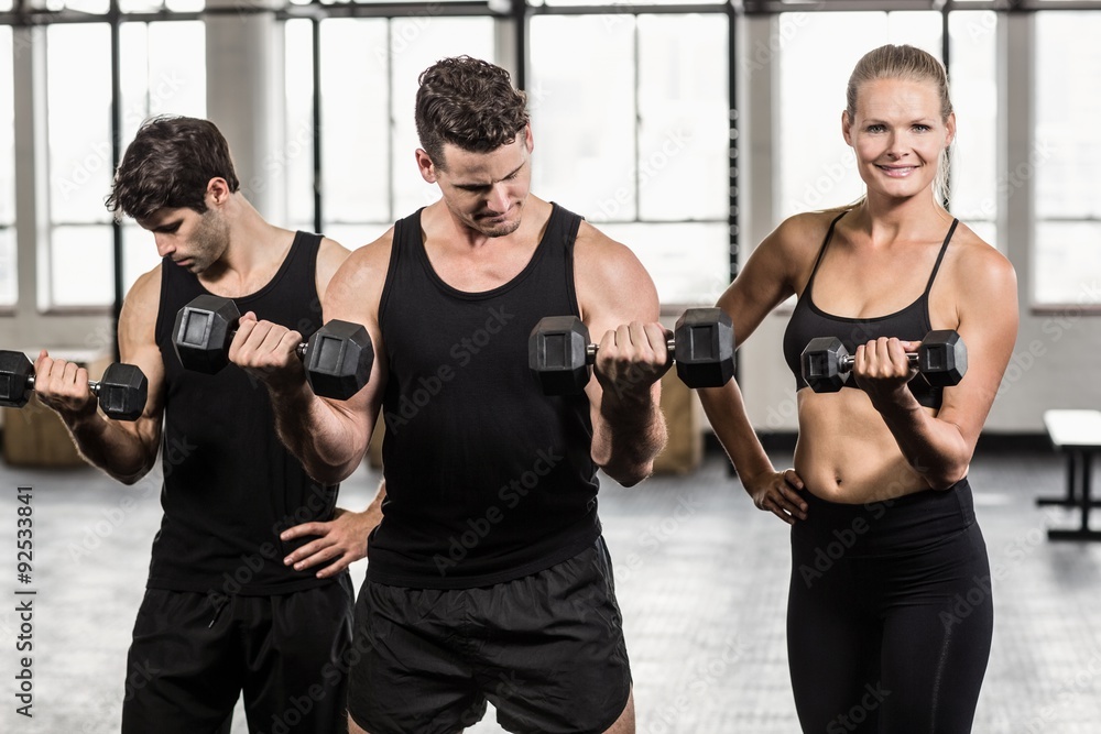 Fit people do some weightlifting together Fit people do some weightlifting together
