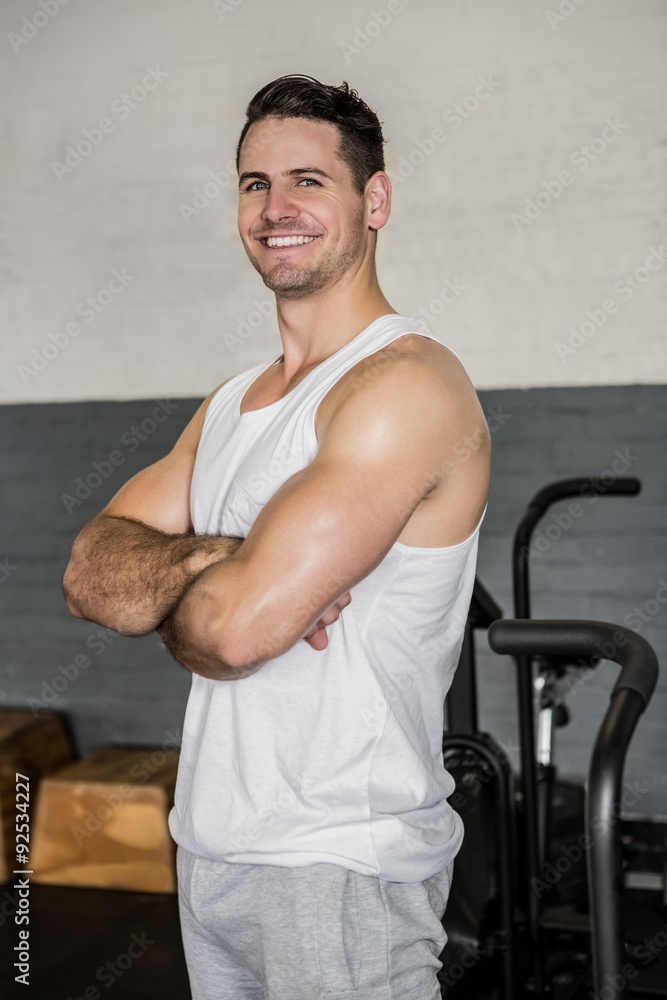 Portrait of a smiling muscular man with arms crossed Portrait of a smiling muscular man with arms crossed