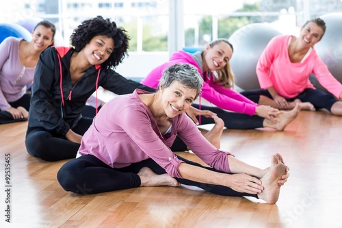 Tableau sur toile Portrait of fit women smiling while exercising