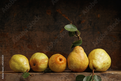 Organic pears on wooden shelf