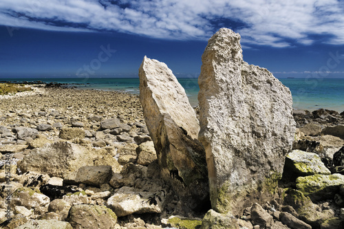 Megalith on dover coastline UK, free standing rocks that point upwards into the clouds under the cliffs at samphire hoe