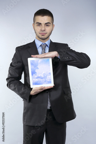 Businessman holding tablet ...