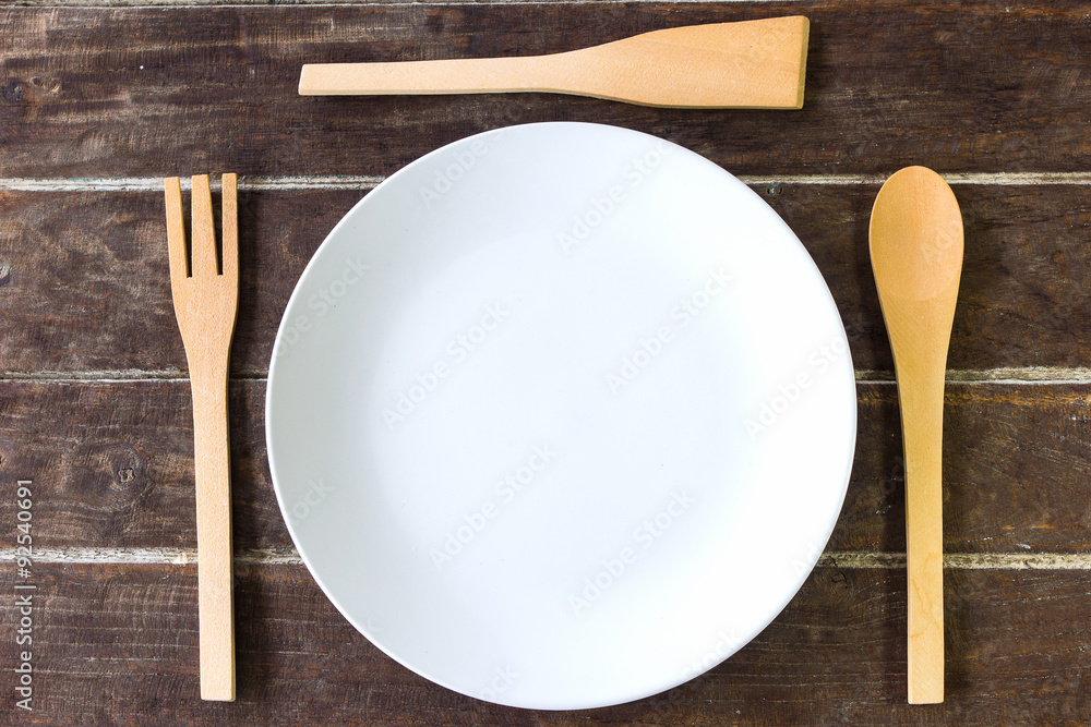wooden fork and spoon and empty plate wooden fork and spoon and empty plate