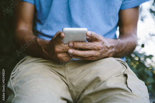 Young man with mobile phone...