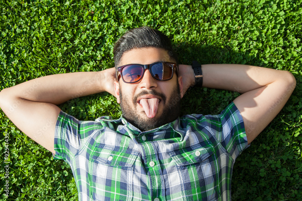 One funny fashion middle eastern man with beard and fashion hair style is  resting on beautiful