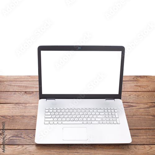Modern laptop on wooden table isolated