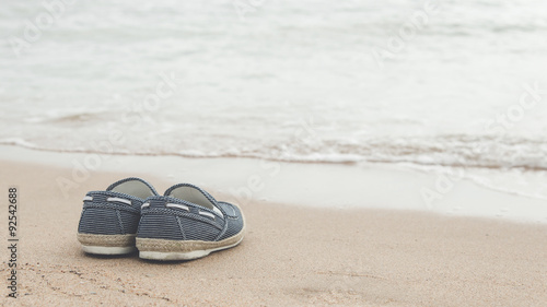 canvas shoes on sand beach