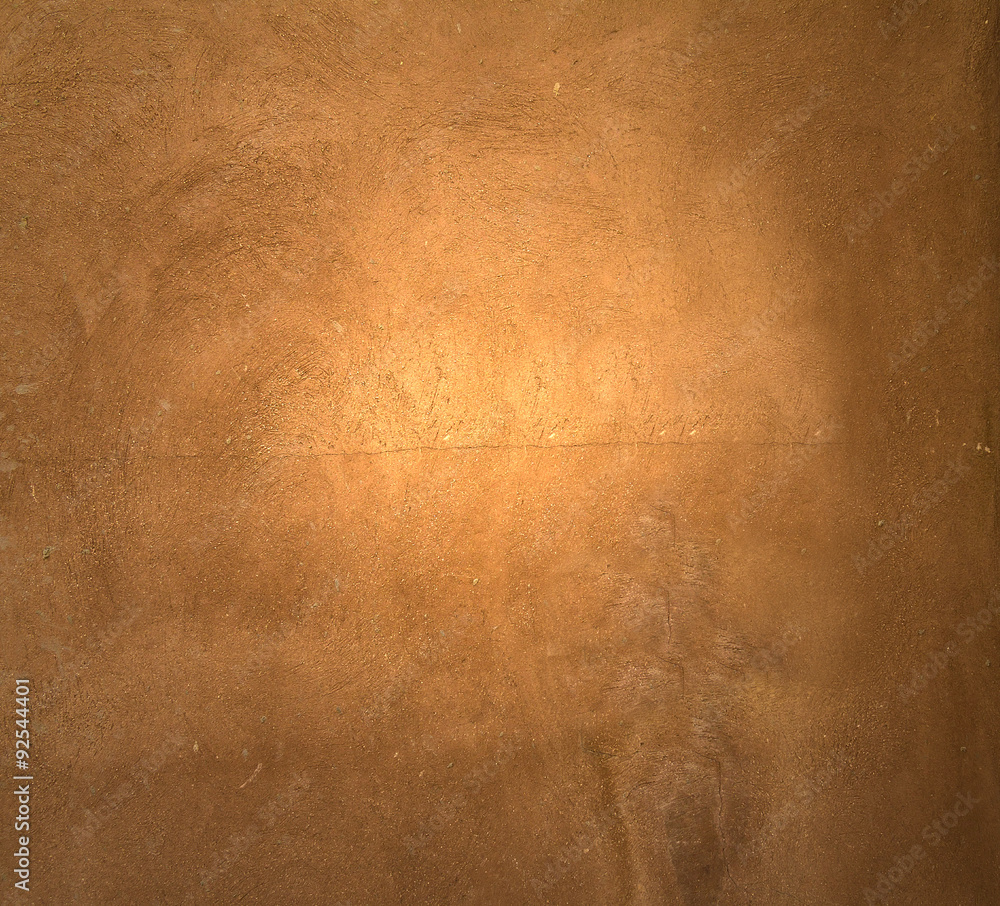 Naklejka premium Brown painted plaster pattern background with spotlight and place for your design or text