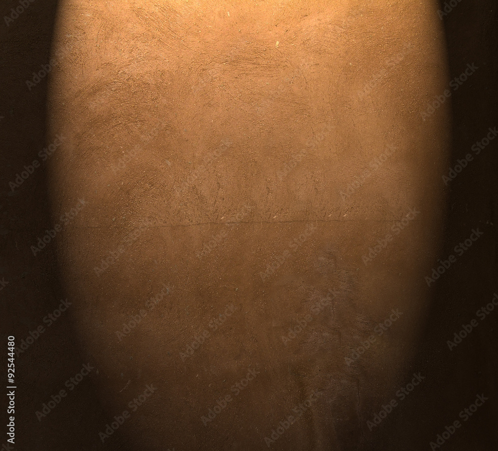 Fototapeta premium Brown painted plaster pattern background with spotlight and place for your design or text