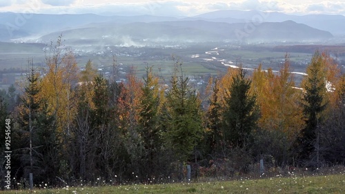 Smooth video panorama of evening autumn premountain plain with river and agricultural lands (Ukraine, Carpathian) photo