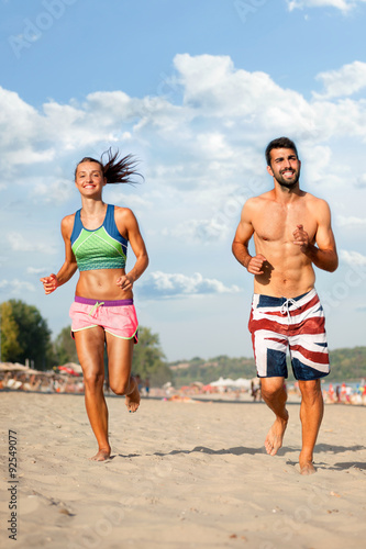  Young couple running on beach