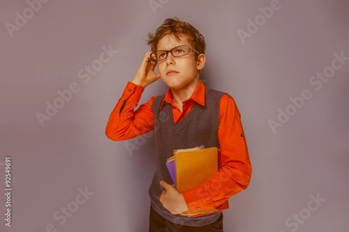 European-looking boy  of ten years  in glasses  thinking  intent