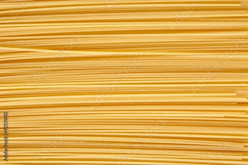 Background made of raw pasta stacked horizontally