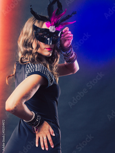 Woman with carnival venetian mask on dark © anetlanda