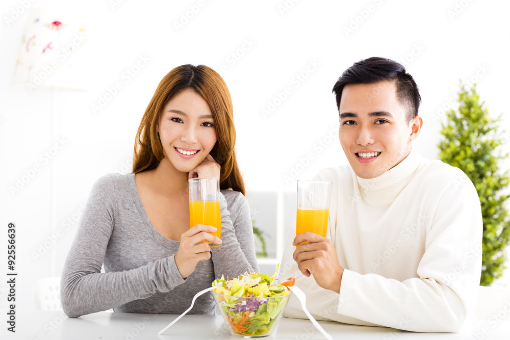 Young smiling couple drinking juice and healthy food Young smiling couple drinking juice and healthy food