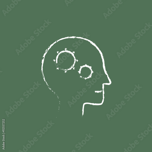 Human head with gear icon drawn in chalk.