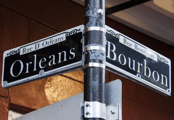 Street signs for Rue D' Orleans and Rue Bourbon in New Orleans, Louisiana