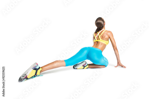 professional sportswoman stretching on white background