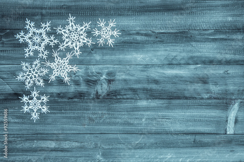 Snowflakes on wood background. Winter holidays decoration