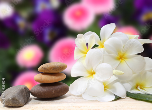 Zen spa concept background - Zen massage stones with frangipani plumeria flower