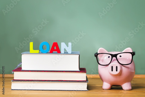 Student loan theme with textbooks and piggy bank photo