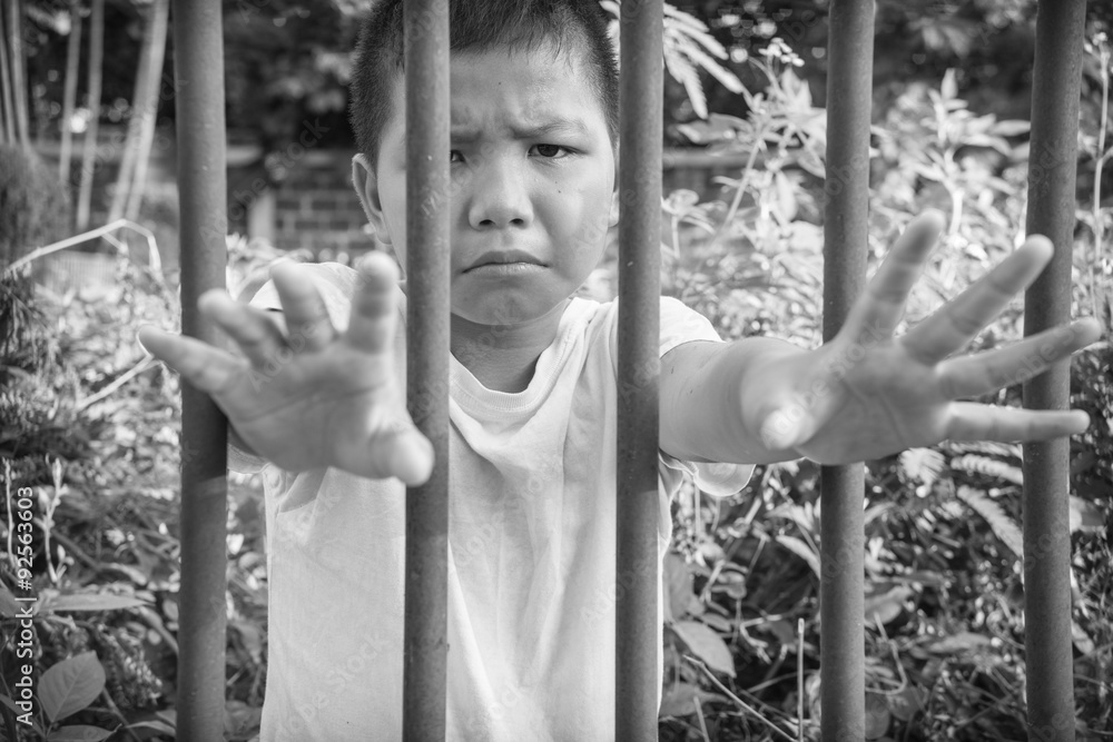 Fototapeta premium Young homeless Asian boy scared and alone, he is at high risk of being abused and trafficked