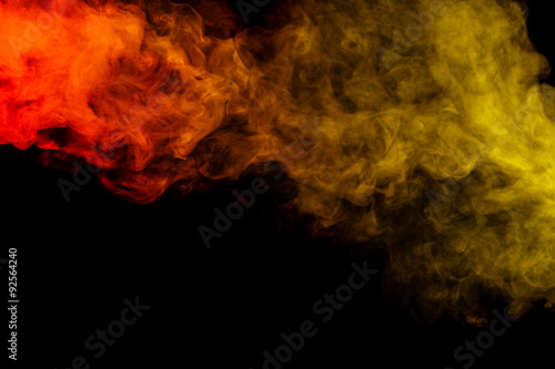 Abstract red and yellow smoke hookah on a black background.