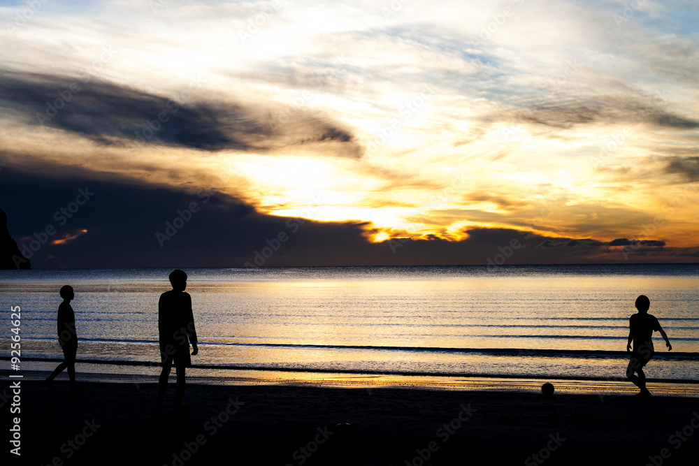 Fototapeta premium man playing football on the beach
