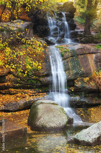 Autumn waterfall  flow. Nature composition.