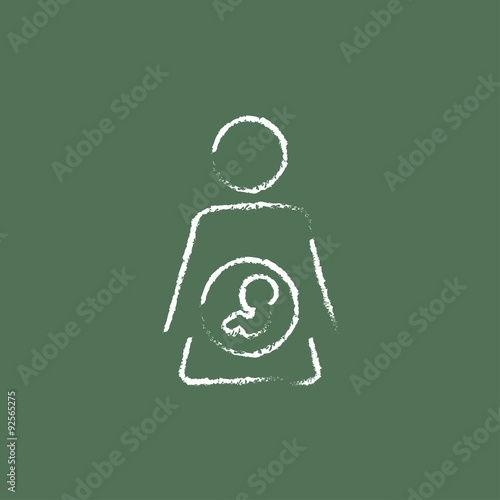 Baby fetus inside of womb icon drawn in chalk.