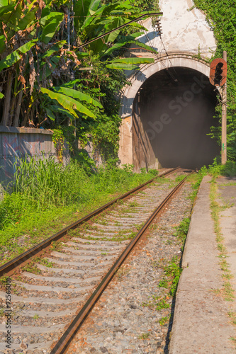 Old railroad with the arch of the tunnel